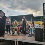 Cinque ragazze sul palco del Disability Pride di Milano